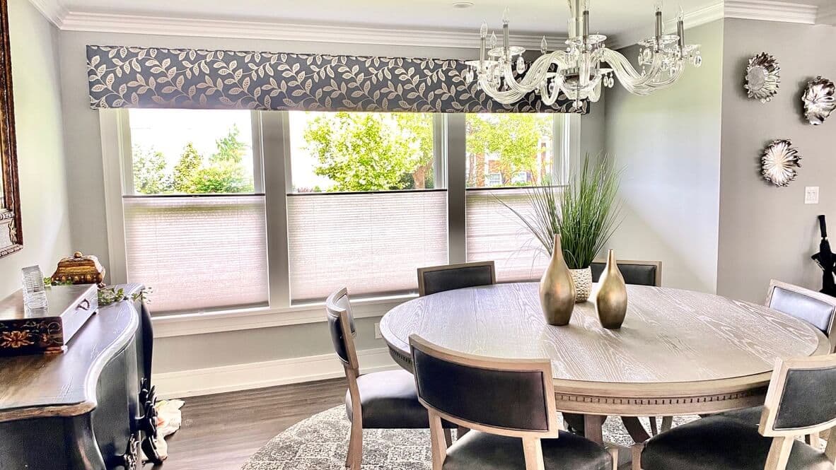 Custom upholstered cornice over cellular shades in a Long Island dining room